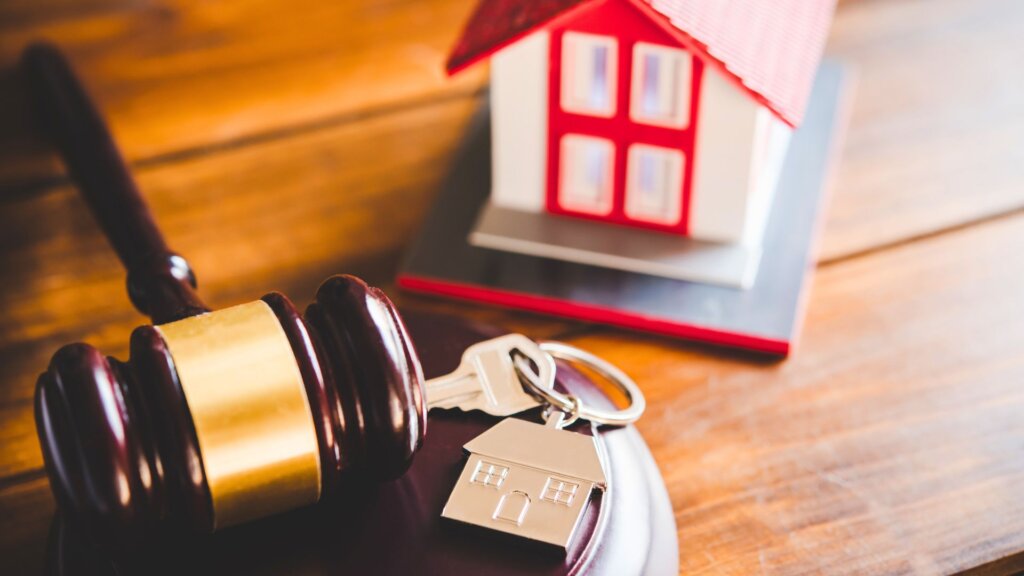Judge’s gavel with house model and keys