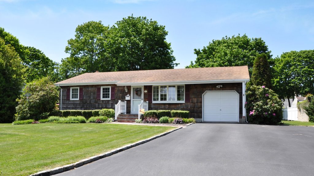Brown single-story house with a spacious driveway