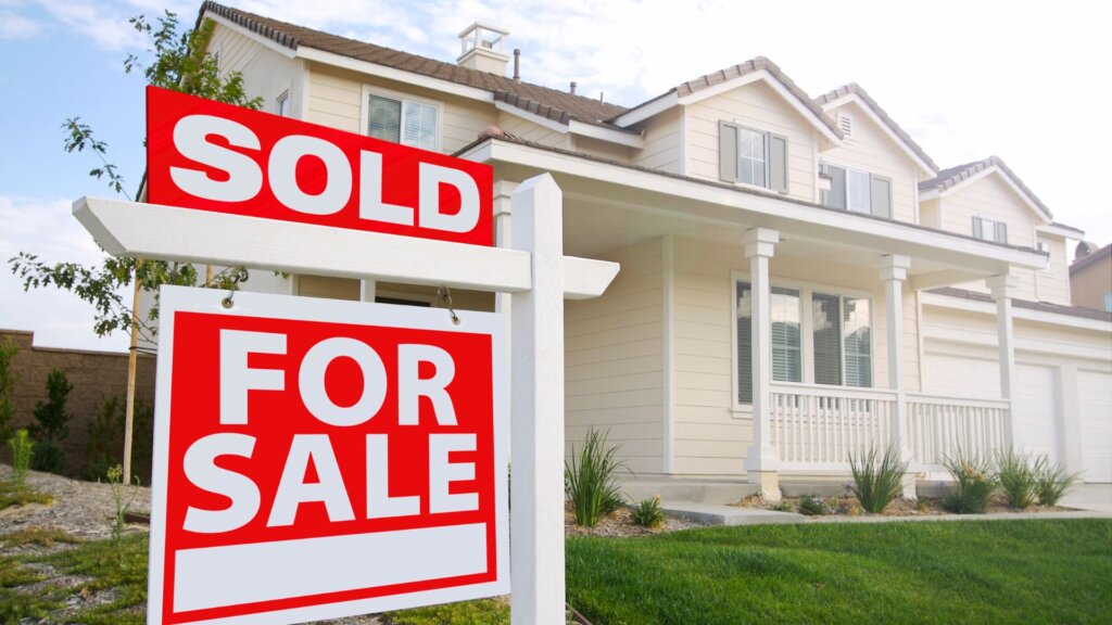 Residential home with sold sign on front lawn