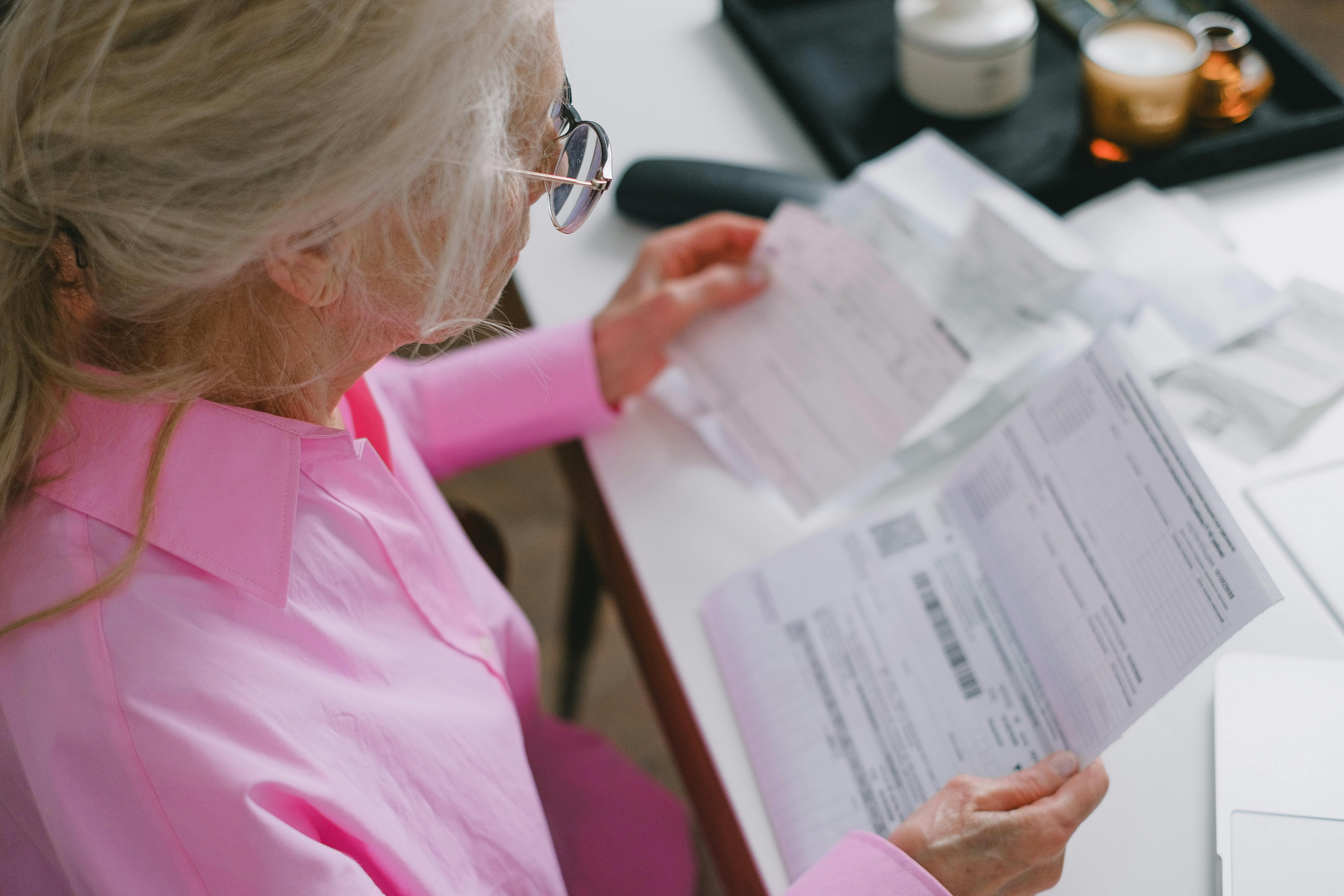 Senior woman reviewing household bills