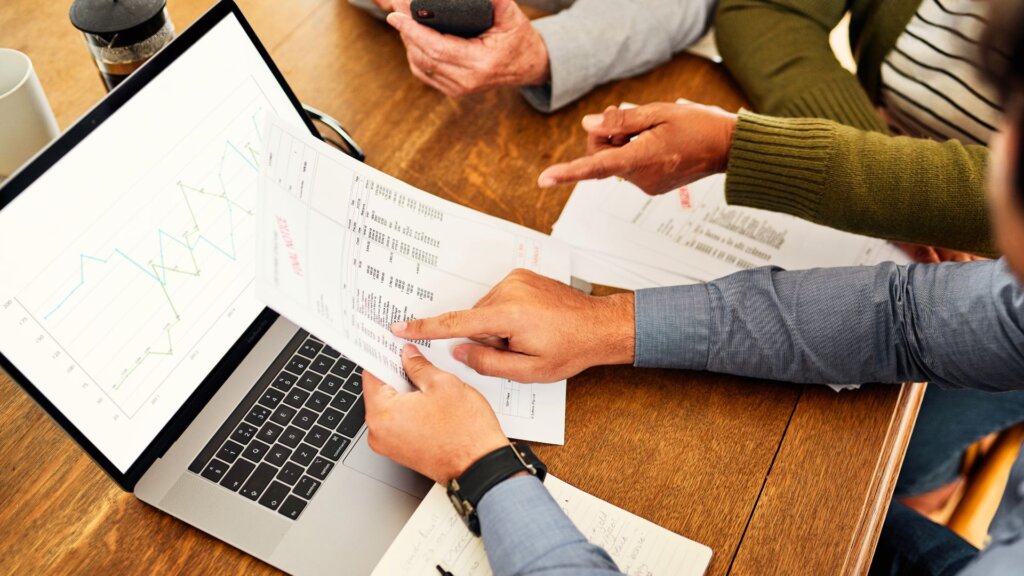 Homeowners meeting with a financial advisor to review paperwork