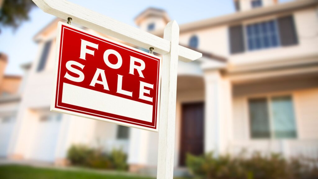 For sale sign in front of residential home
