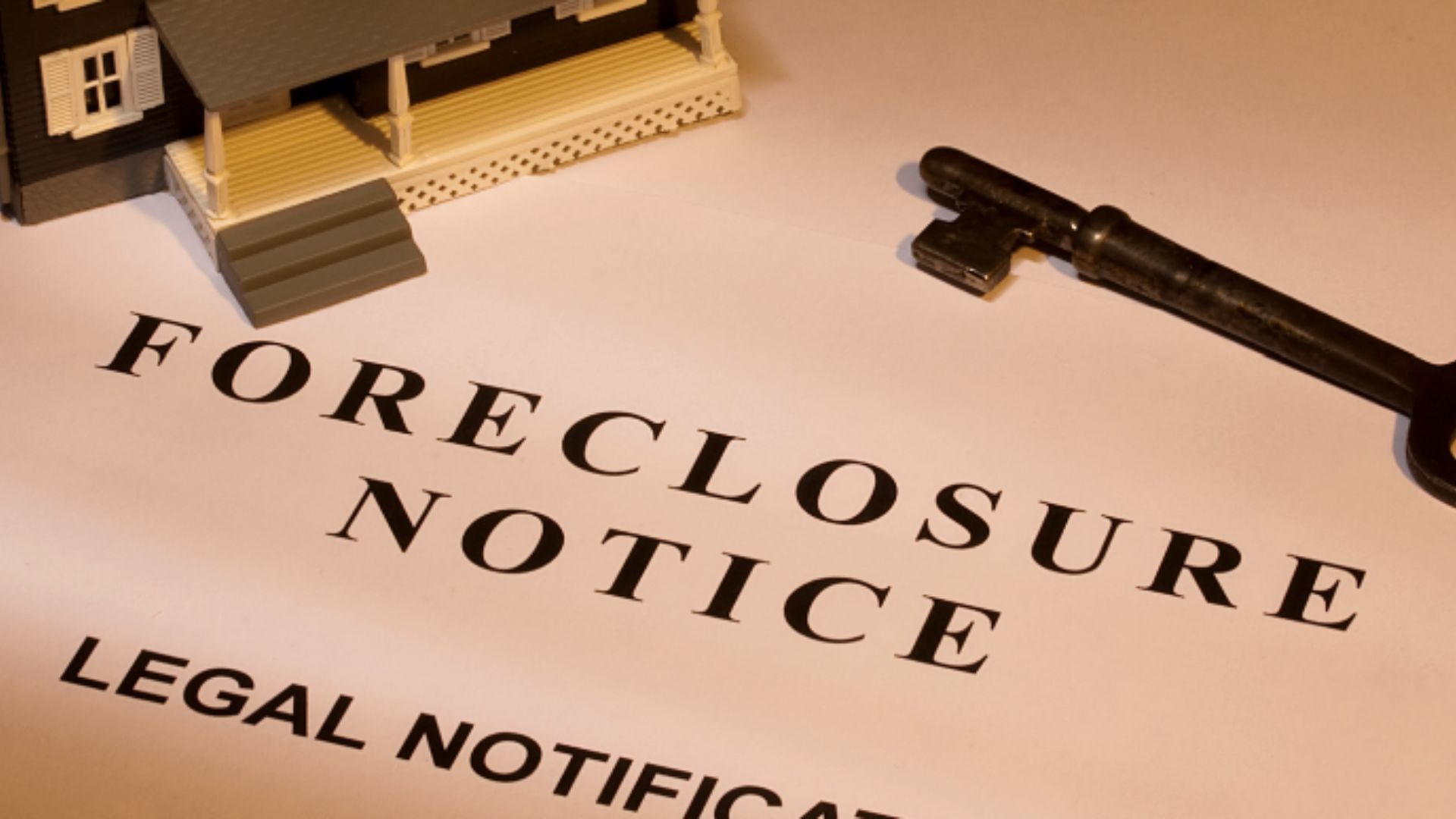 Foreclosure notice document with house model and key