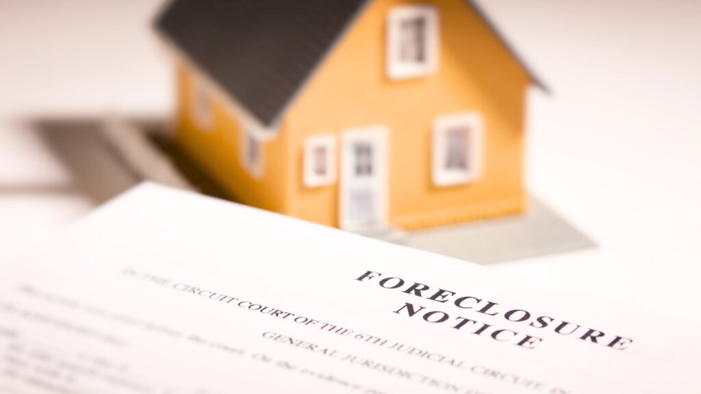 Foreclosure notice document with house model in background