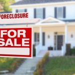 Home with foreclosure sign in yard