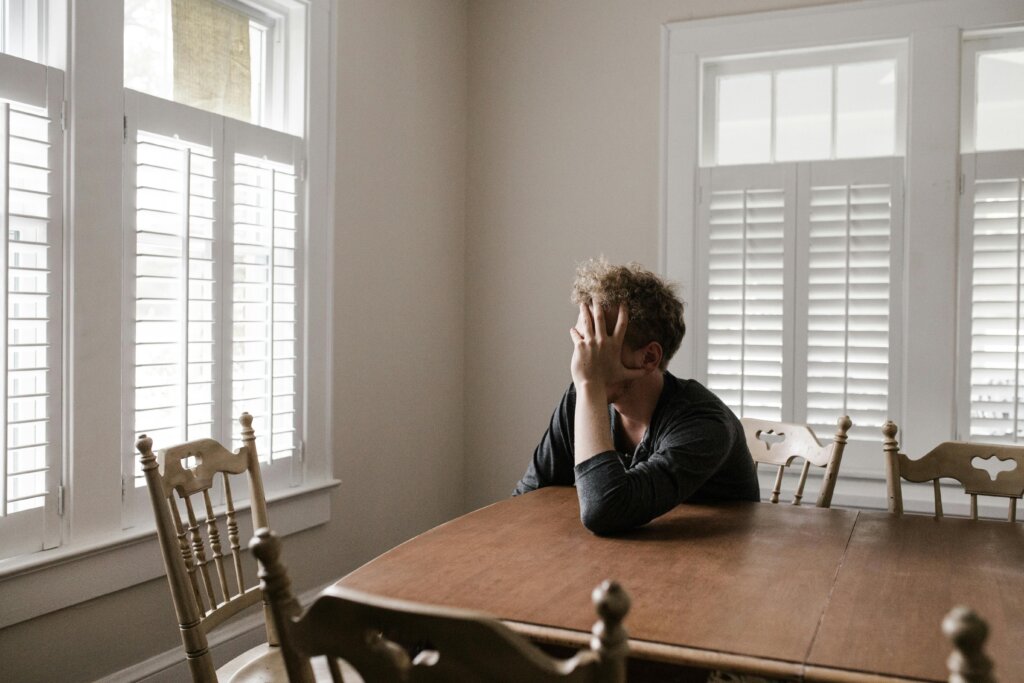 Homeowner sitting at table looking stressed