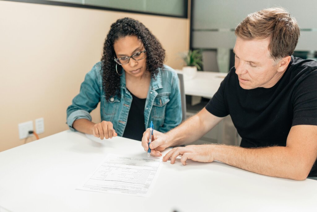 Couple reviewing and signing paperwork together