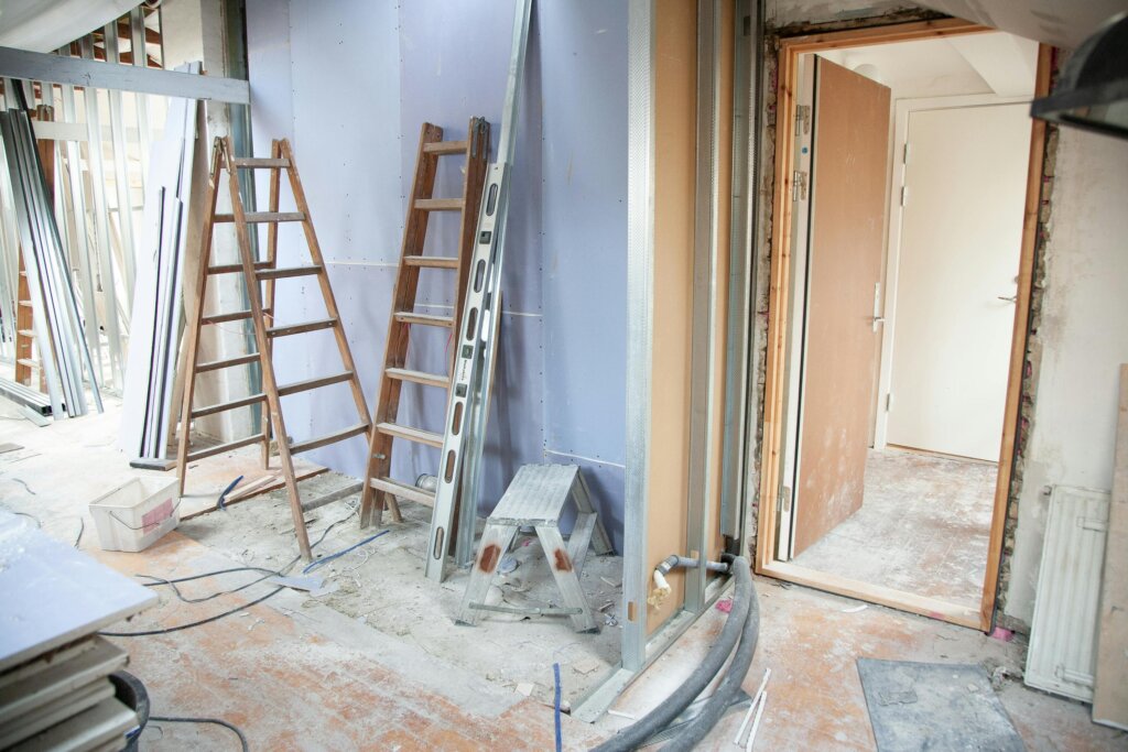 Interior room under renovation with ladders and construction materials