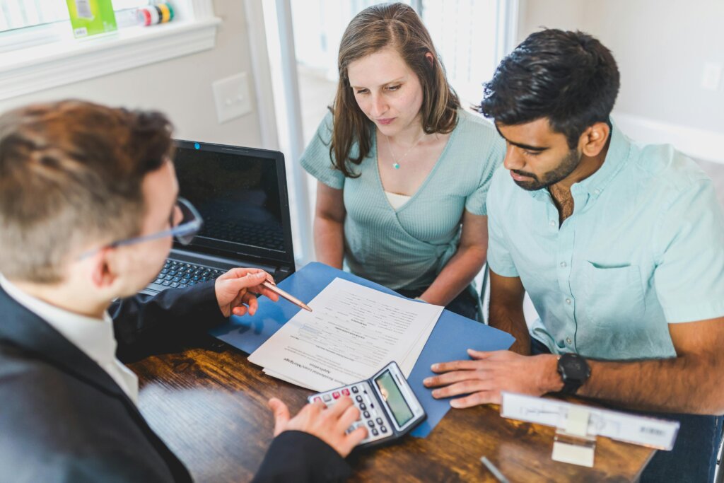 Professional reviewing financial paperwork with couple